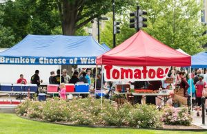 Photo of tomatoes and cheese tents at the Dane County Farmers Market