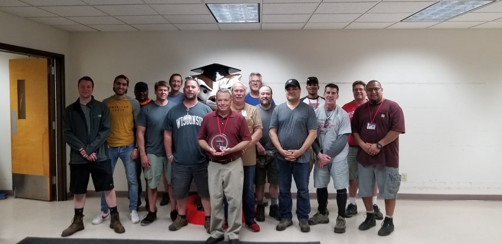 Photo of Brad Schenkel and 14 colleagues from the Campus Services team within the Physical Plant department