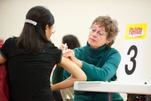 Nurse giving a woman a flu shot