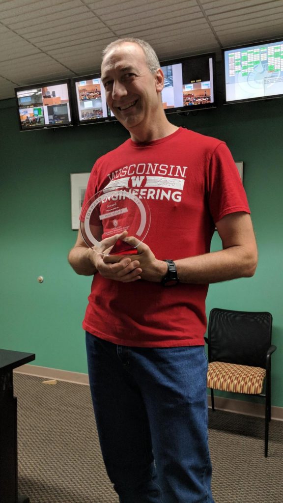 Photo of Mike Kedzie holding his award