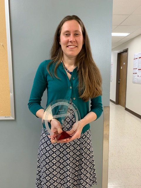 Carrie Niziolek holding award