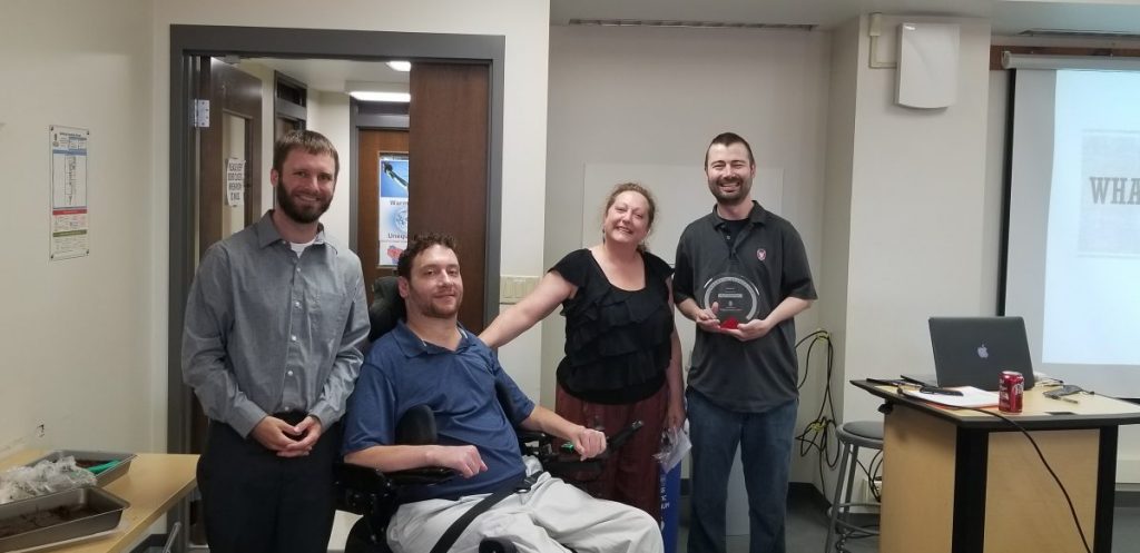 Photo of Left to Right: Front DesPhoto of Ryan Keegan, Mike Mohr, Kris Wurgler, and Dr. Matt Bowman in an office setting