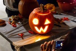 Illuminated carved pumpkin with a W mouth