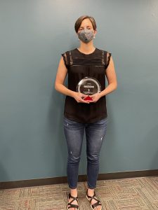 Angela Zito stands with award