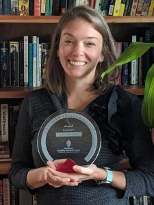 Picture of Laura holding her award
