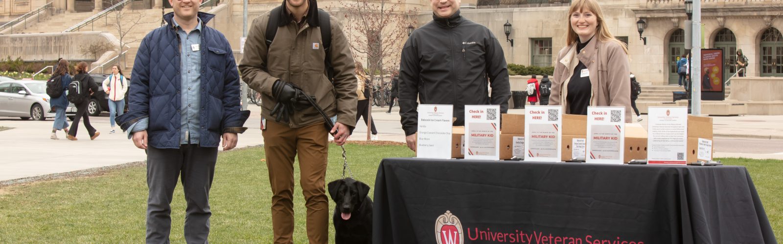 Staff from University Veteran Services with Alex Boruch and his dog, Nina, at this year's ice cream social on Library Mall.
