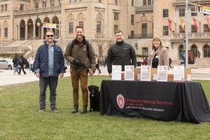 Staff from University Veteran Services with Alex Boruch and his dog, Nina, at this year's ice cream social on Library Mall.