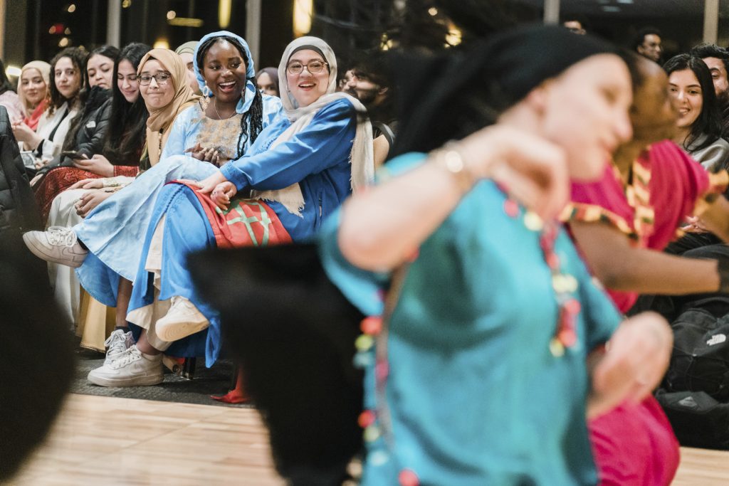 The audience enjoys a North African dance performance by the African Students Association
