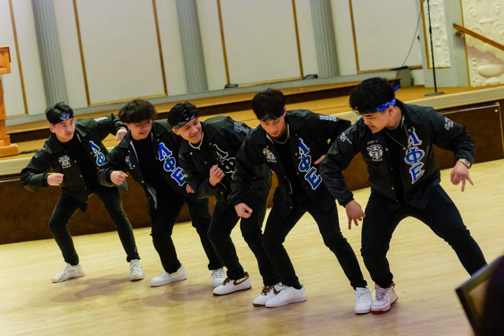 Members of Lambda Phi Epsilon perform.