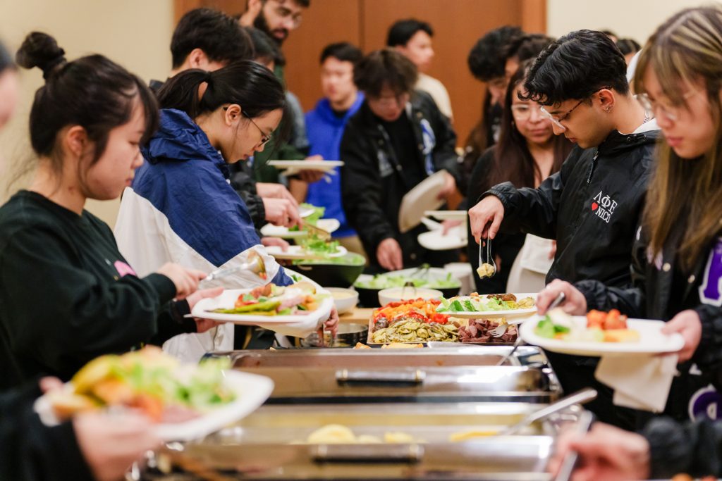 Attendees enjoy food at the Multicultural Council 50th Anniversary celebration.