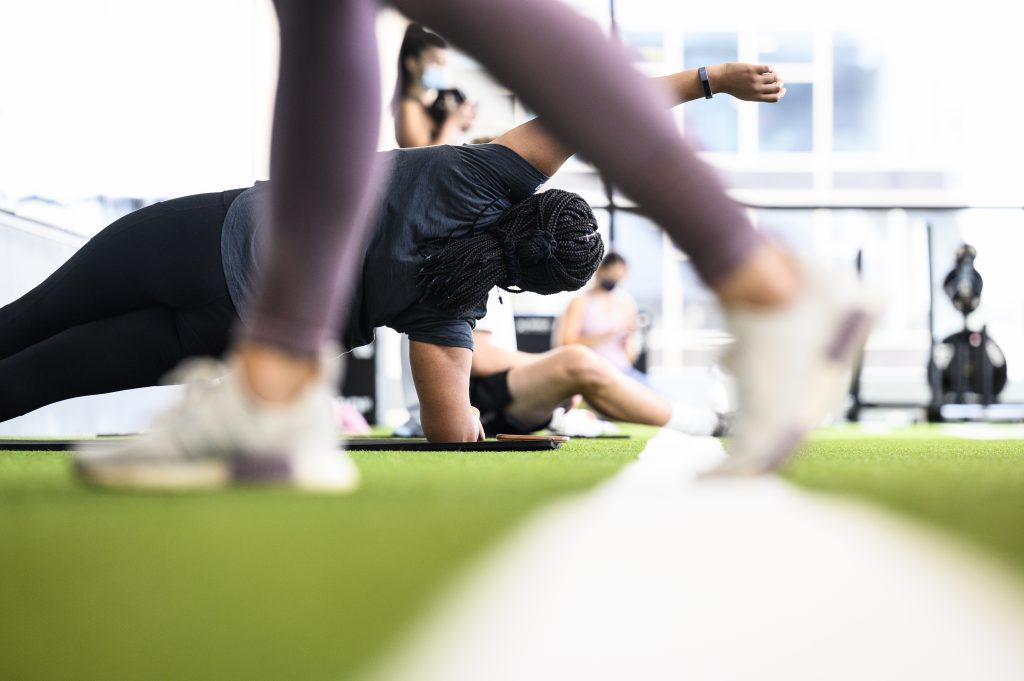 Students stretch and workout in the turf movement area in the Nicholas Recreation Center.