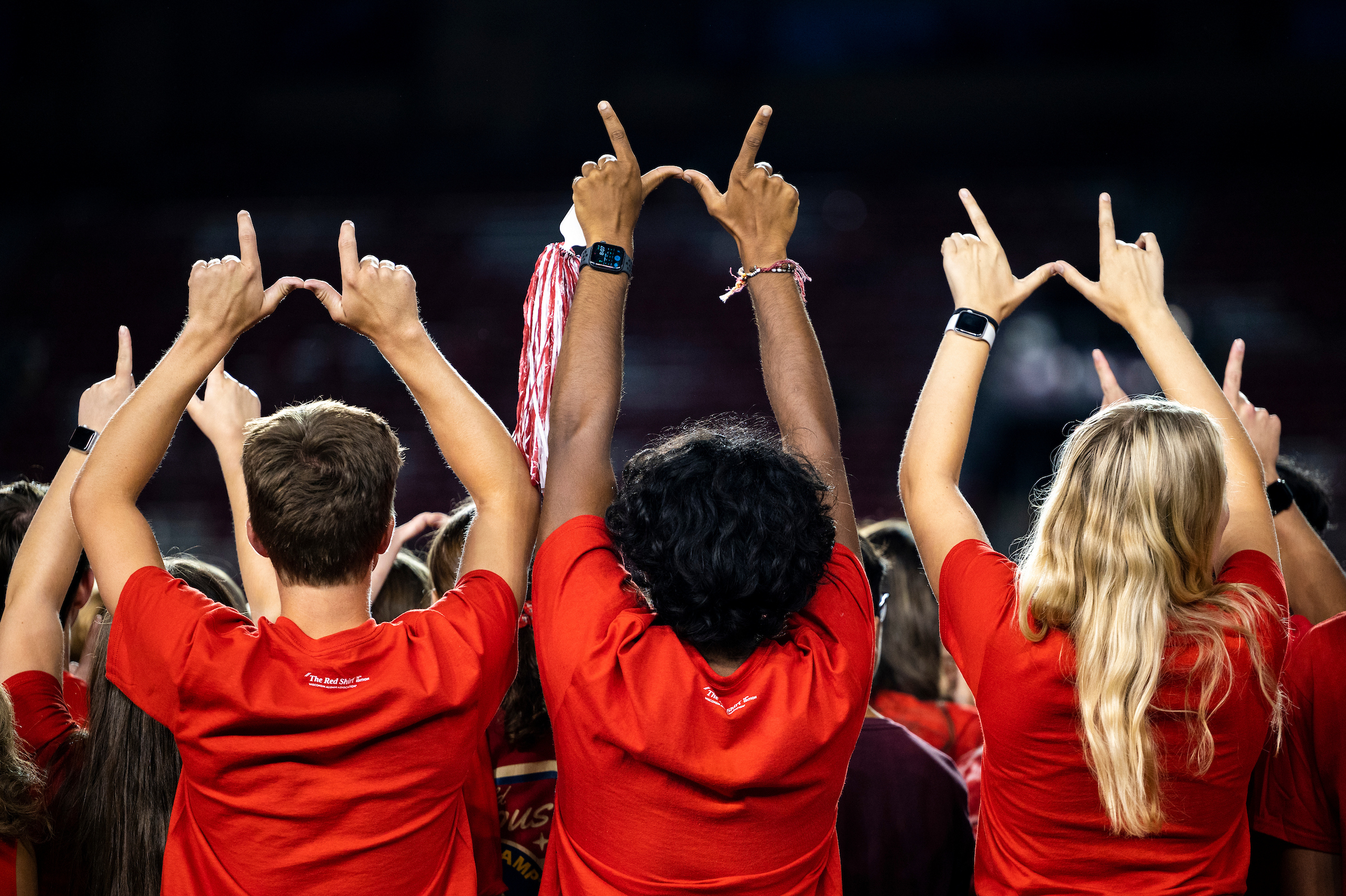 First-year students create the letter "W" with their hands during the W Project on Barry Alvarez Field at Camp Randall Stadium.