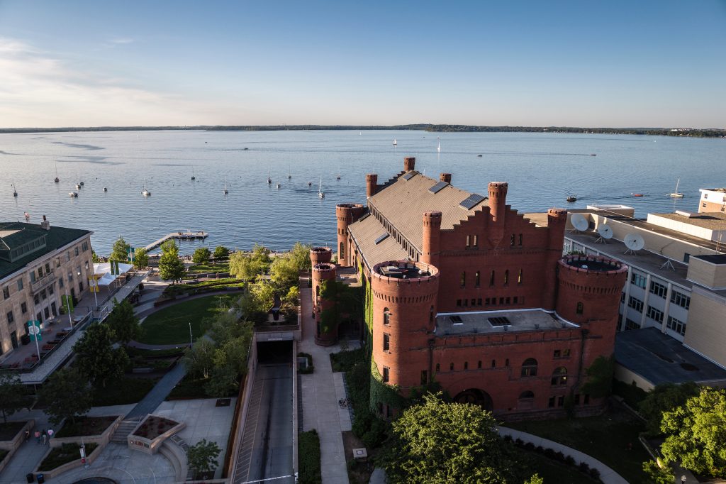 Lake Mendota dotted with boats is pictured in an aerial view with the Red Gym in the foreground at the University of Wisconsin–Madison on June 10, 2024. (Photo by Bryce Richter / UW–Madison)