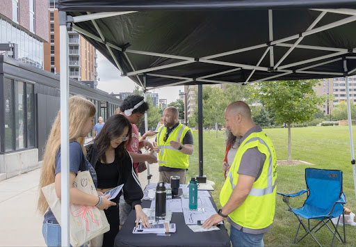 Students stop by the Badgers on the Bus Resource table to learn more about routes and services from Madison Metro Transit staff. 