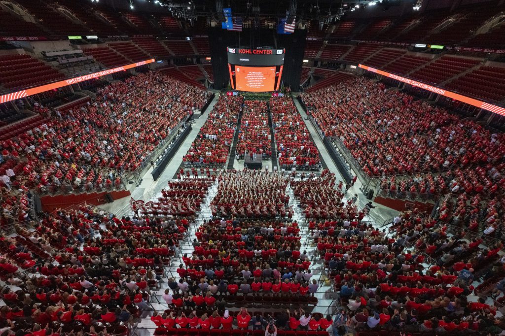 The UW Marching Band hypes up students before Convocation starts at the Kohl Center.