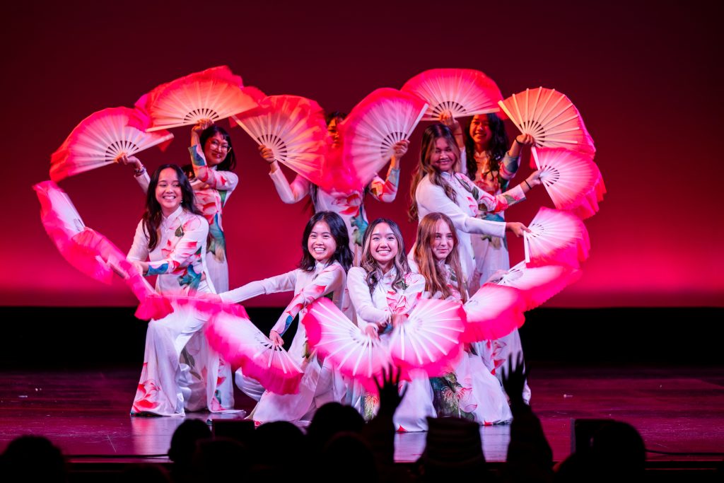 People dancing on stage during the MCOR showcase.