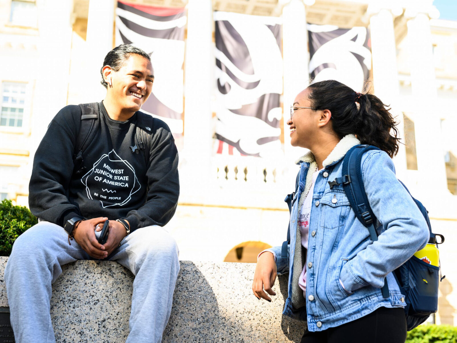 Undergraduate students taking a break, talk in front of Bascom Hall.