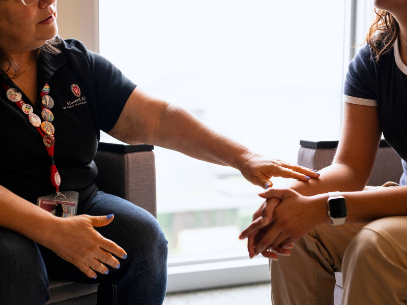 Staff member speaks with a student at a visit