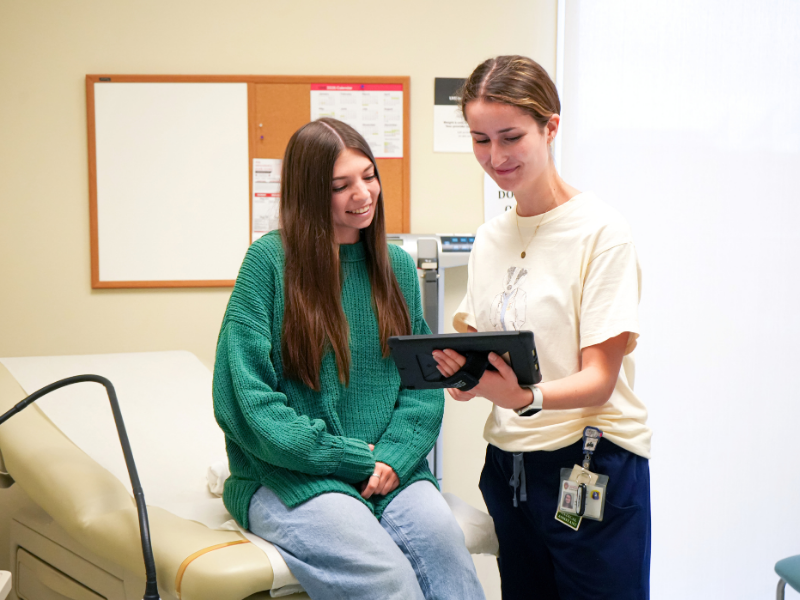 A student talks with a provider at a medical appointment