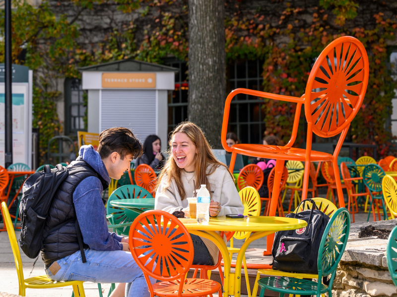 Two individuals sit outside at The Terrace and enjoy a conversation