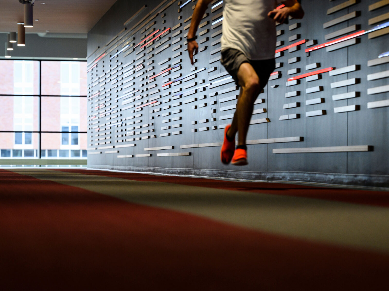 A runner runs on an indoor track at the Nicholas Recreation Center